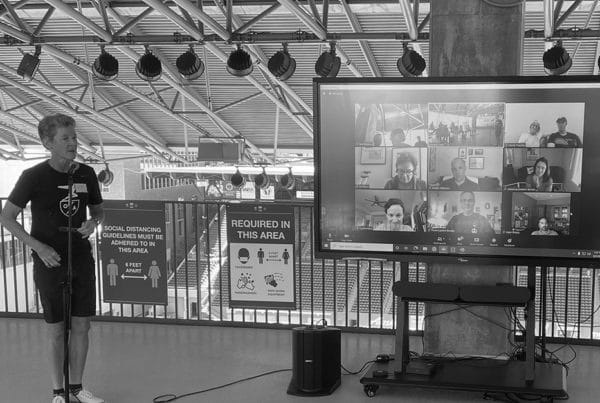 Kate presenting to group and people on zoom